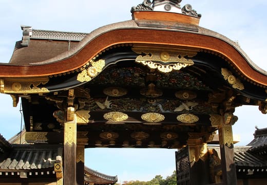 The carved and gilded Karamon gate of Nijo Castle under a blue sky, Kyoto