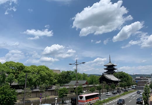 The five storey pagoda of To-ji rising above the trees along Kujo-dori, Kyoto