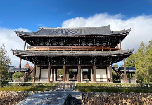 The two-storey wooden Sanmon gate of Tofuku-ji under a blue sky, Kyoto