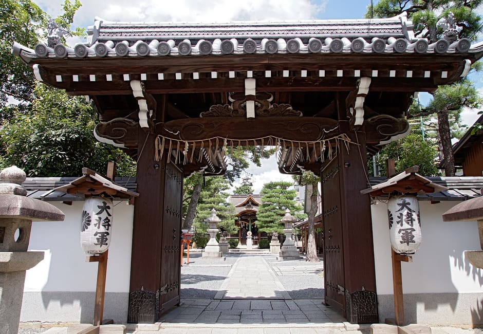 The gate of Daishogun Hachi Shrine with its two Daishogun lanterns, looking through to the stone path and hall
