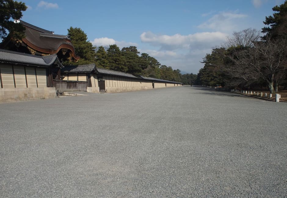 A wide gravel avenue beside the Imperial Palace wall in Kyoto Gyoen National Garden