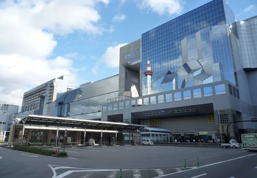 The glass and steel facade of Kyoto Station seen from the plaza in front