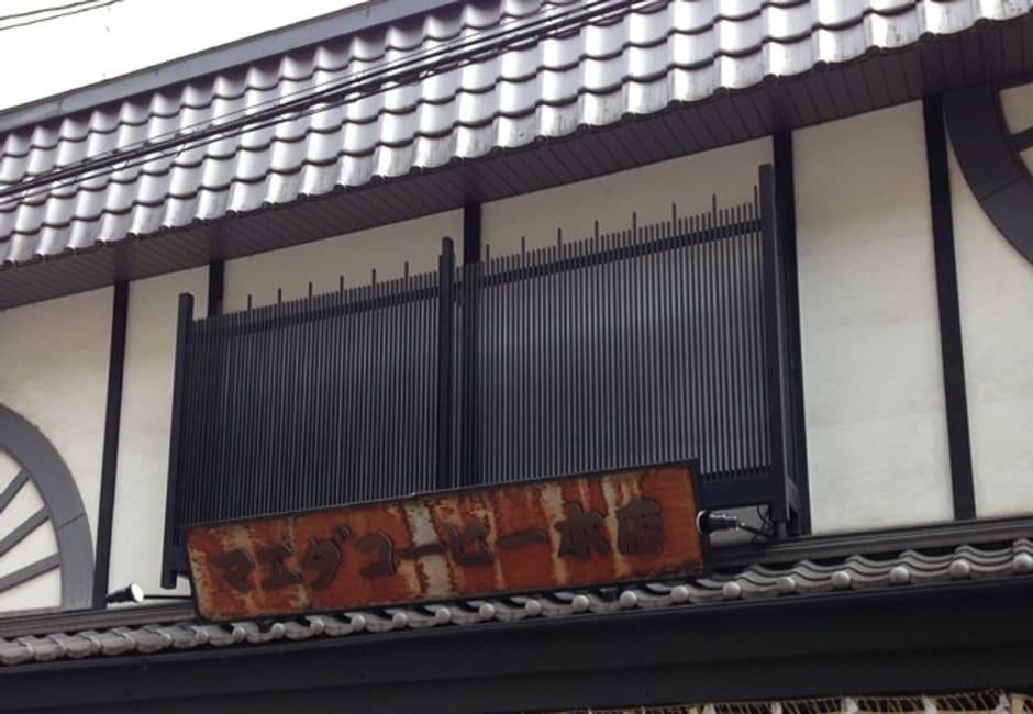 Maeda Coffee's tiled wooden shopfront with white noren curtains near Shijo-Karasuma in Kyoto