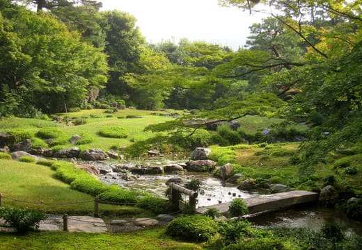 The lawn, stream and stepping stones of the Murin-an villa garden in Okazaki, Kyoto