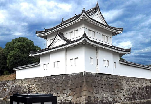 The white corner turret of Nijo Castle above its stone wall and moat