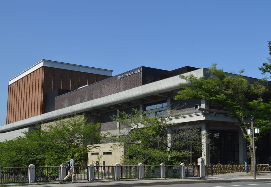The modernist exterior of ROHM Theatre Kyoto in Okazaki under a clear blue sky