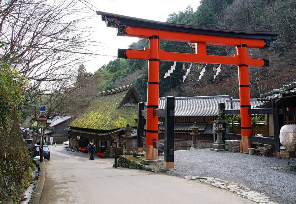 The red torii and a thatched teahouse on the Saga-Toriimoto preserved street, Kyoto