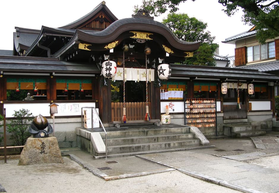 The main hall of Seimei Shrine with lanterns bearing its star emblem, Kyoto